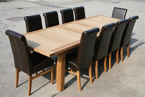 2.4 - 2.9m Tallinn extending table with luxury dark brown Emperor leather chairs with roll back.  Table 699, chairs 79 each at our oakdiningsets website
